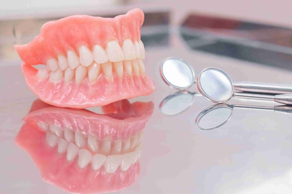 A high-quality removable partial denture shown alongside a smiling patient at Aghbashian Dental in Glendale, CA 91202, illustrating affordable tooth replacement solutions.